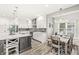 Bright kitchen featuring white cabinets, modern stainless steel appliances, and a spacious island with seating at 10697 Woodmont Ln, Fishers, IN 46037