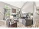 Spacious living room featuring a fireplace, vaulted ceiling, and comfortable seating at 10697 Woodmont Ln, Fishers, IN 46037