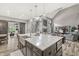 Open-concept living room with a large kitchen island, vaulted ceiling, and sliding barn doors at 10697 Woodmont Ln, Fishers, IN 46037