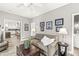 Inviting living room with a sofa, chest, and view into the open kitchen at 10697 Woodmont Ln, Fishers, IN 46037