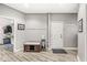 Inviting mudroom features durable wood flooring, coat hooks, and a convenient storage bench at 10697 Woodmont Ln, Fishers, IN 46037