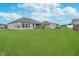 Spacious backyard featuring lush green grass, a shed, and privacy fence at 107 Elliott Ave, Trafalgar, IN 46181