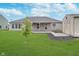 Backyard showcasing landscaping, green grass, and a shed at 107 Elliott Ave, Trafalgar, IN 46181