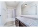 Bright bathroom featuring a tub, single sink vanity with marble countertop, and natural light at 107 Elliott Ave, Trafalgar, IN 46181