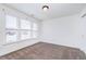 Bedroom filled with natural light showcasing a window and a neutral carpet at 107 Elliott Ave, Trafalgar, IN 46181