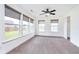 Brightly lit bedroom with large windows, neutral carpet, a ceiling fan, and closet at 107 Elliott Ave, Trafalgar, IN 46181