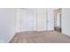 Bedroom showcasing closet and doors with neutral carpet at 107 Elliott Ave, Trafalgar, IN 46181