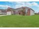 Well maintained brick home featuring a manicured lawn, landscaping and a two car garage at 107 Elliott Ave, Trafalgar, IN 46181