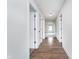 Open hallway with laminate flooring provides access to the home's bedrooms and living areas at 107 Elliott Ave, Trafalgar, IN 46181
