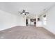 Bright and open living room featuring neutral carpet, ceiling fan, and views to the kitchen at 107 Elliott Ave, Trafalgar, IN 46181