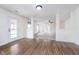 Open-concept living room with wood-look floors, ample natural light, and a spacious layout at 107 Elliott Ave, Trafalgar, IN 46181