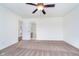 Spacious main bedroom features a ceiling fan and connects to an ensuite bathroom for added privacy at 107 Elliott Ave, Trafalgar, IN 46181