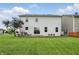 View of the house from the backyard, featuring a spacious lawn and a deck at 10722 Landsbrook N Run, Noblesville, IN 46060