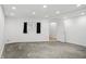 Unfinished basement featuring concrete floors, white walls, window, and access to another room at 10722 Landsbrook N Run, Noblesville, IN 46060