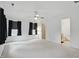 Large bedroom has neutral carpet, a ceiling fan, and an ensuite bathroom at 10722 Landsbrook N Run, Noblesville, IN 46060