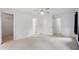 Large bedroom boasts neutral carpet with two doorways, and white walls at 10722 Landsbrook N Run, Noblesville, IN 46060