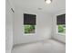 Bright bedroom with neutral carpet features two windows with privacy shades, and white walls at 10722 Landsbrook N Run, Noblesville, IN 46060