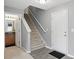 Bright entryway featuring tile floors, neutral paint, and stairs to the upper level at 10722 Landsbrook N Run, Noblesville, IN 46060