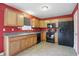 Well-appointed kitchen with wood cabinets, stainless steel appliances, and tile floors at 10722 Landsbrook N Run, Noblesville, IN 46060
