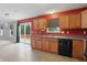 Functional kitchen featuring wood cabinets, tile floors, and modern appliances at 10722 Landsbrook N Run, Noblesville, IN 46060