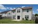 Rear exterior of the home showing vinyl siding, windows, sliding glass door, and green lawn at 1129 Central Park S Blvd, Greenwood, IN 46143