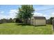 Well-maintained backyard with a shed, mature tree, and plenty of green space at 1129 Central Park S Blvd, Greenwood, IN 46143