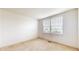 Bright bedroom with a large window and neutral carpeting provides a blank canvas for customization at 1129 Central Park S Blvd, Greenwood, IN 46143
