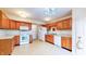 Bright kitchen featuring wooden cabinets, white appliances, and ample counter space at 1129 Central Park S Blvd, Greenwood, IN 46143