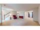 Spacious living room with carpet, natural light, and a view of the dining area and staircase at 1129 Central Park S Blvd, Greenwood, IN 46143