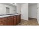 Bathroom with double sink vanity, large mirror, and tile flooring at 11531 Short Iron Ln, Indianapolis, IN 46235