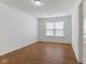 Bedroom featuring hardwood floors, window, and neutral decor at 11531 Short Iron Ln, Indianapolis, IN 46235