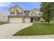 Inviting two-story home with a well-manicured lawn, three-car garage, and classic curb appeal at 11531 Short Iron Ln, Indianapolis, IN 46235