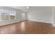 Spacious living room with wood floors, large windows, and a ceiling fan at 11531 Short Iron Ln, Indianapolis, IN 46235
