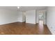 Light-filled living room featuring wood floors and a doorway to another room at 11531 Short Iron Ln, Indianapolis, IN 46235