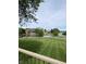 Lush green backyard with a serene lake view, creating a peaceful oasis at 12231 Valley View Cir, Indianapolis, IN 46229
