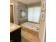Relaxing bathroom with a jetted tub, tiled surround, granite countertop, and decorative wall art at 12231 Valley View Cir, Indianapolis, IN 46229