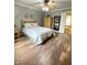 Bedroom featuring hardwood floors, neutral walls, wooden furniture, and an open door to the bathroom at 12231 Valley View Cir, Indianapolis, IN 46229
