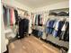 Spacious walk-in closet with custom shelving and hardwood flooring, perfect for organization and storage at 12231 Valley View Cir, Indianapolis, IN 46229