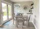Charming dining area with a gray table set, French doors to the outdoors, and a stylish bar area at 12231 Valley View Cir, Indianapolis, IN 46229