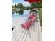 The dock features outdoor seating with colorful flowers and a picturesque lakeside view at 12231 Valley View Cir, Indianapolis, IN 46229