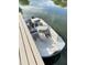 The fishing boat is parked on the lake next to the wooden dock at 12231 Valley View Cir, Indianapolis, IN 46229