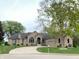 Beautiful brick home with a well-manicured lawn and curved driveway at 12231 Valley View Cir, Indianapolis, IN 46229