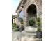 Charming front entrance with stone steps, manicured plants, and lantern-style lights at 12231 Valley View Cir, Indianapolis, IN 46229