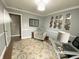 Inviting office space with a comfortable chair, patterned rug, and modern artwork for a stylish workspace at 12231 Valley View Cir, Indianapolis, IN 46229