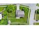 Overhead view of a property showcasing a well-manicured lawn, fenced backyard, and neighborhood at 1234 Breaside Cir, Greenwood, IN 46143