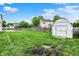 Expansive backyard featuring a green lawn, wooden privacy fence, and a storage shed at 1234 Breaside Cir, Greenwood, IN 46143