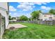 A sprawling backyard with a lush green lawn, concrete patio, and a wooden privacy fence at 1234 Breaside Cir, Greenwood, IN 46143