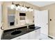 Bright bathroom featuring a double sink vanity with black granite countertops and white cabinetry at 1234 Breaside Cir, Greenwood, IN 46143