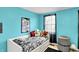 Teal bedroom featuring a patterned bed, stuffed animals, and window at 1234 Breaside Cir, Greenwood, IN 46143