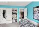 Bedroom featuring teal walls, a patterned bed, and open closets at 1234 Breaside Cir, Greenwood, IN 46143